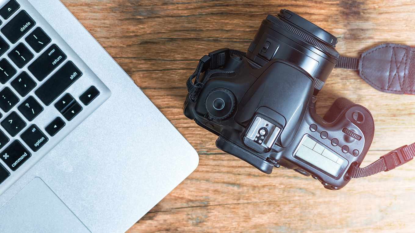Uma câmera e um notebook sobre a mesa